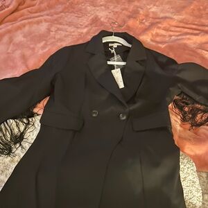 Very nicer black romper ( dressy) with fringing on sleeves, never worn, new